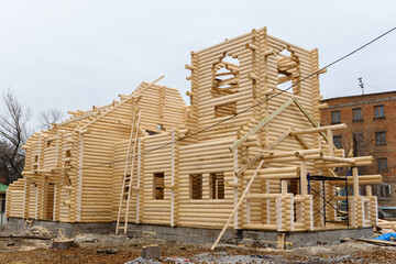 Construction of a Christian church made of wooden treated logs