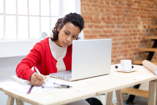 Young Brunette Woman Working Hard From Her Home Office.  Space For Text. Concept Of Plans And New Projects.