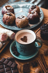 turquoise cup of hot coffee on grey background with cinnamon sticks 