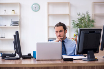 Young male employee working in the office