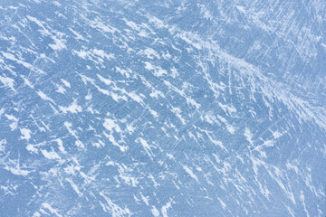 Frozen lake ice texture with snow. Winter background.