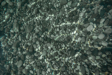 Stones at the bottom visible through the clear sea water