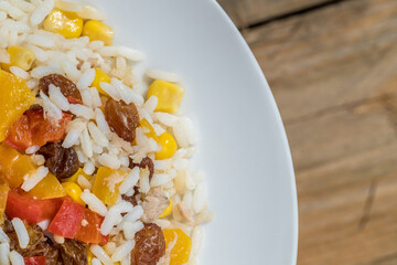 rice with yellow and red pepper and dried grapes and corn, eat healthy