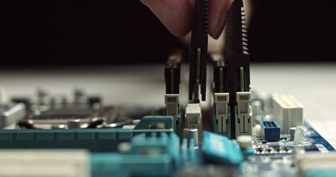High tech. The process of installing RAM on a computer motherboard. Close-up 4K