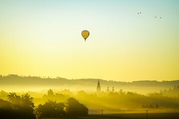 view from the field, balloon over the small town