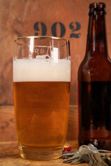 Beer Glass and Bottle - Beer in Glass has Foam