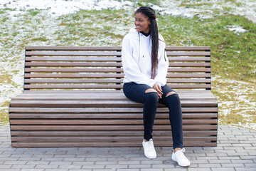 Fototapeta premium happy African American woman in the Park on a bench