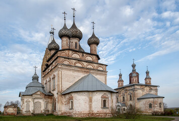 An old rural temple in need of restoration, domes against the sky.