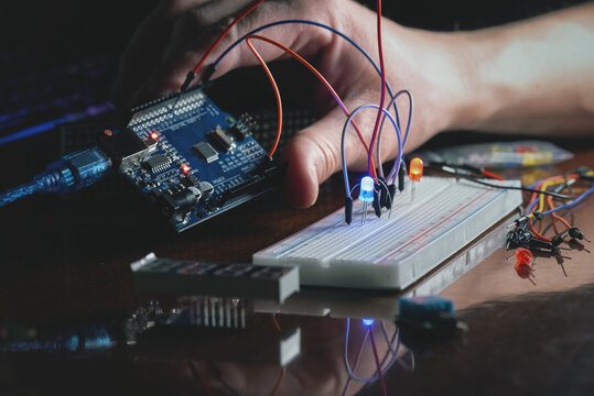 Man learns the basics of programming microprocessors close up.