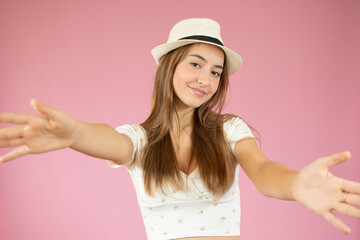 smile teenage excited girl raised up palms arms hands at you, isolated over pink background concept of freedom happy student, young pretty woman asking us to come up hug