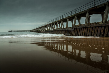 Morning at Blyth beach in Northumberland, England, with the old wooden Pier stretching out to the North Sea