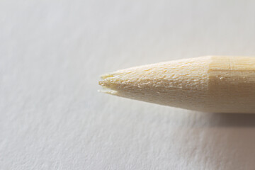 Closeup view of a broken pencil without lead rod on a white paper background