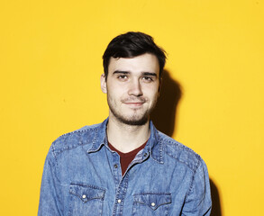 Obraz premium young man posing over yellow background, casual style