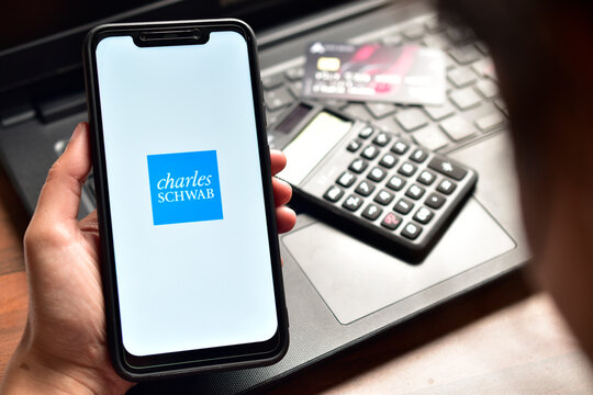 New Delhi, India - December 15, 2019: Using Charles Schwab application on smartphone
