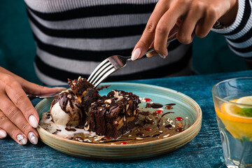 woman eating chocolate dessert close up