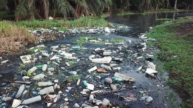 Move toward dark river full of rubbish garbage bottle, plastic