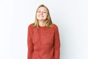 Young blonde woman isolated on white background laughs and closes eyes, feels relaxed and happy.