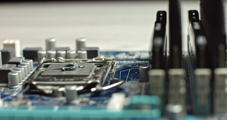Fototapeta na wymiar Build computer concept. Close-up shot of applying thermal paste on cpu. 4k footage. Close-up of smudging hermal paste on processor of notebook with spoon. Thermal grease for better cooling of device