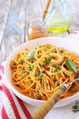 Spaghetti in a spicy red sauce, capers and olives