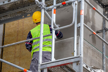 Plastering wall with trowel