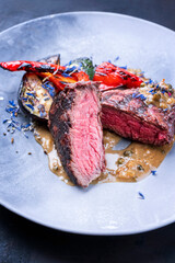 Modern style barbecue dry aged wagyu roast beef pepper steak with barbecue vegetable in pepper...