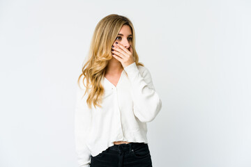 Young caucasian blonde woman thoughtful looking to a copy space covering mouth with hand.
