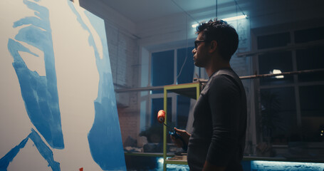 Modern artist painting in workshop