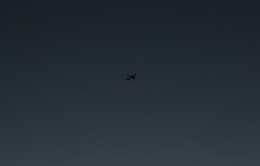 airplane silhouette with indigo blue sky in the background
