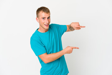 Young caucasian handsome man excited pointing with forefingers away.
