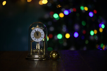 Christmas composition with clock and beautiful bokeh in the background