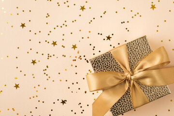 Top above close up view photo of beautiful present box with golden ribbon standing on shiny glitter table with place for header