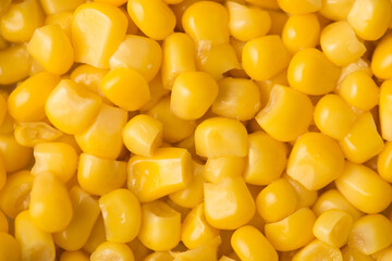 Close-up top above view photo of yellow bright sweet canned corn textured background