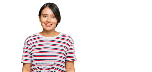 Beautiful young woman with short hair wearing casual clothes with a happy and cool smile on face. lucky person.