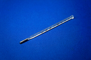 Mercury thermometer isolated on a blue background 