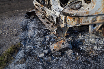 Burned down car, abstract background, selective focus. The situation of protests in the world.