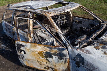 Burned down car, abstract background, selective focus. The situation of protests in the world.