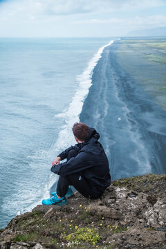 Portrait fo a man with the sea and black sand in the background
