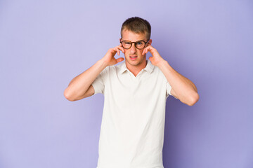 Young caucasian handsome man covering ears with fingers, stressed and desperate by a loudly ambient.