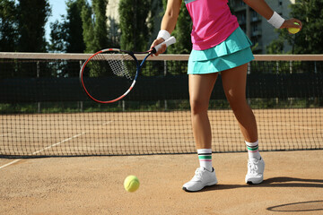 Fototapeta na wymiar Sportswoman playing tennis at court on sunny day, closeup