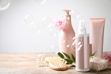 Set of hair cosmetic products, flowers and soap bubbles on white background. Space for text