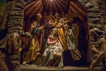Traditional Christmas nativity scene with beautiful figures made out of wood. The birth of Jesus Christ in the manger surrounded by Joseph, Mary and shepherd.