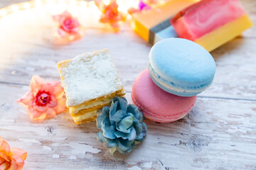 Fototapeta na wymiar handmade soap in the form of macarons and cakes on a wooden background. natural soap and cosmetics