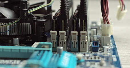 Connecting wires in a computer. Components inside the system unit. Video card and RAM on the...