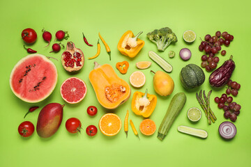 Fresh organic fruits and vegetables on green background, flat lay