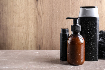 Set of different men's cosmetic products on beige marble table. Space for text