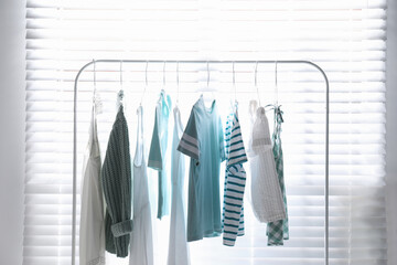 Rack with stylish women's clothes indoors. Interior design