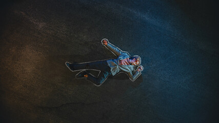 Top Down Shot of a Bloody Man with Chalk Outline Lying on the Pavement after Criminal Accident on a Street at Night. Young Man was Shot in Head. Concept of Horrbile Murder with Death.