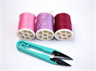 sewing thread and needle ,Sewing spool of thread and scissors isolated on white background	