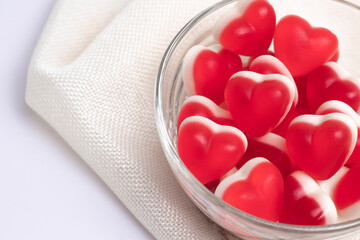 Gelatin hearts in a glass transparent saucer on a white background. Valentine's day concept.