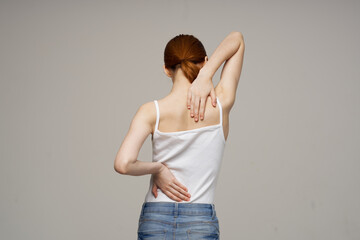woman in white t-shirt problems with trunks pain osteoporosis